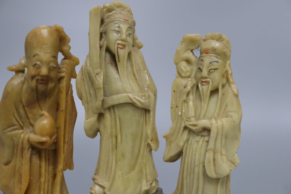 Three Chinese soapstone carvings of immortals, on base, height 19cm